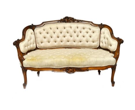 A diminutive Victorian carved walnut show frame sofa with button upholstery, 125cm wide x 84cm high.