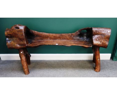A 20th century naturalistic dug out bench, 175cm wide x 85cm high.