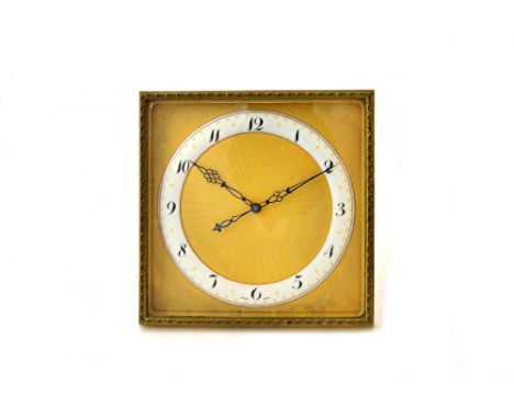 A French eight day strut back timepiece, circa 1900, the ormolu square frame and bevelled glass panel enclosing an enamelled 