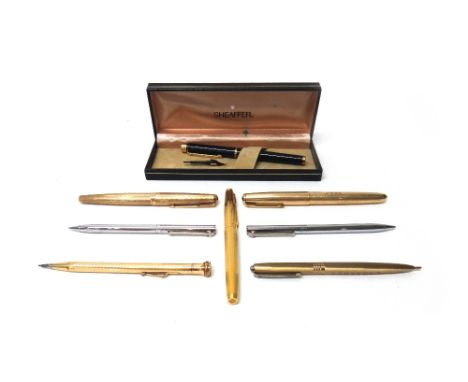 A 9ct gold cased Parker fountain pen, having engine turned decoration, London 1970, a gilt metal mounted black plastic Sheaff