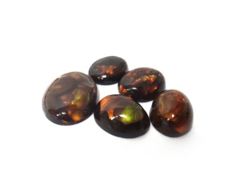 A collection of unmounted gemstones, including; demantoid garnets, chrysoberyls, peridots, five cabochon fire agates, a small
