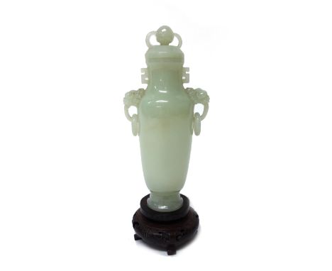 A Chinese pale celadon jade two-handled vase and cover, 20th century, of tapered cylindrical form, set with lion mask and rin