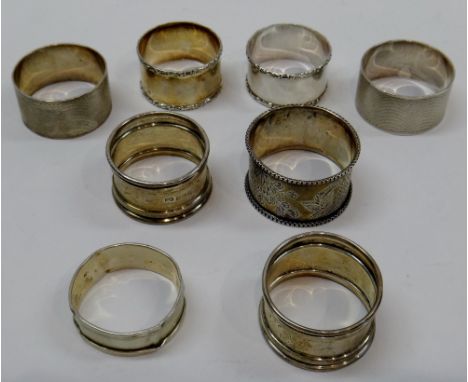 A pair of silver napkin rings, having engine turned decoration, Birmingham 1962 and six further silver napkin rings, combined