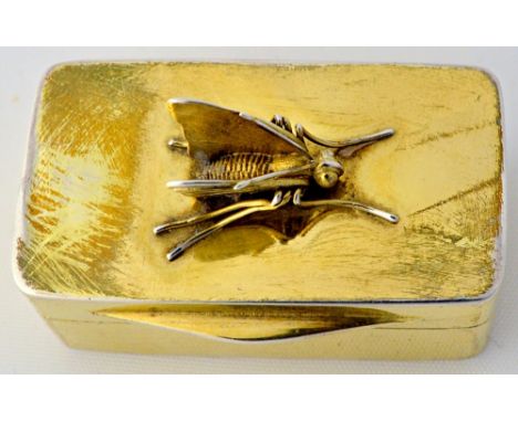 A George IV silver-gilt snuff box of rectangular form, with a finely modelled cast butterfly to the lid and a projecting thum