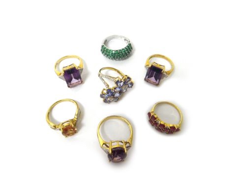A 9ct white gold and emerald ring, in a bombe cluster design and six 9ct vary coloured gem set rings, in a variety of designs