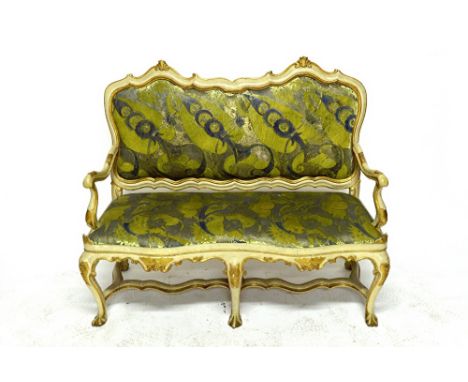 An 18th century North Italian cream and parcel gilt painted sofa, with shaped padded back and seat, on six cabriole supports,