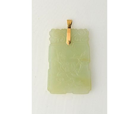 A Chinese pale celadon jade pendant late 19th/20th, of shaped rectangular form carved on one side with a sprig of peony, the 