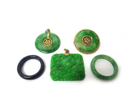 A carved jade rectangular pendant, with foliate decoration, two rings, a circular jade pendant and a circular jade brooch, (5