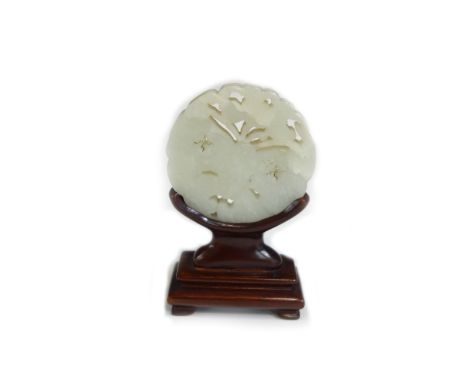 A Chinese pale celadon jade circular plaque, 20th century, carved in low relief and pierced as a butterfly with peony flower,