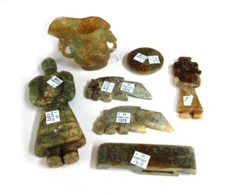 A group of seven Chinese archaistic jade carvings comprising; a libation cup, 9cm.high; a sword slide; two mythical beast pen