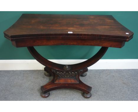 An early 19th century rosewood card table, with concave top and open elliptic support, 97cm wide x 73cm high.