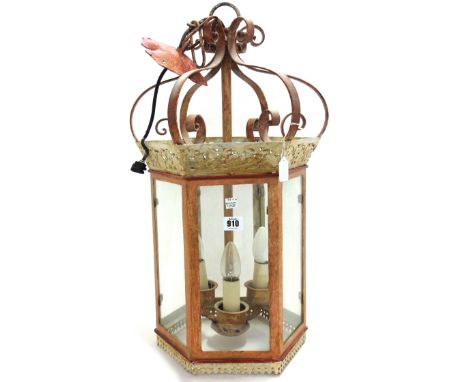 A modern polychrome decorated wrought metal hall lantern of hexagonal form, with internal three light fitment, 60cm high.  57