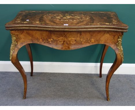 A Victorian gilt metal mounted figured walnut marquetry inlaid card table of serpentine outline, on cabriole supports, 93cm w