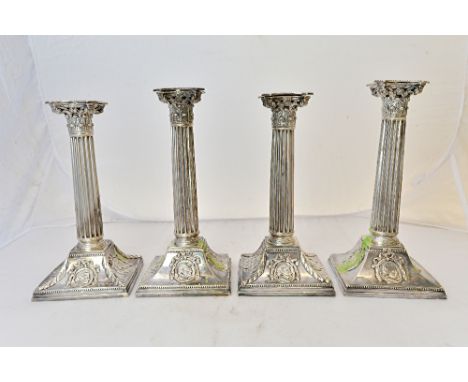 Two pairs of similar table candlesticks, possibly German, first half of the 19th century, each designed as a Corinthian colum