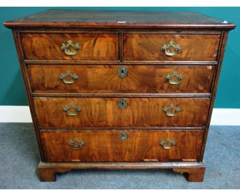 A mid 18th century oak and walnut chest of two short and three long graduated drawers on bracket feet, 93cm wide x 86cm high.