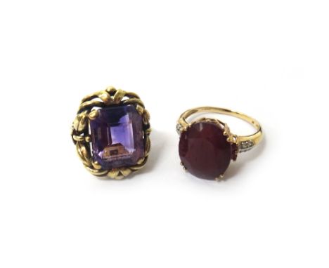 A 9ct gold ring, claw set with an oval cut ruby between diamond set four stone shoulders, ring size S and an amethyst set sin