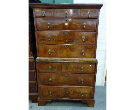 A George II walnut chest-on-chest of three short and six long graduated drawers, on bracket feet, associated, 101cm wide x 17