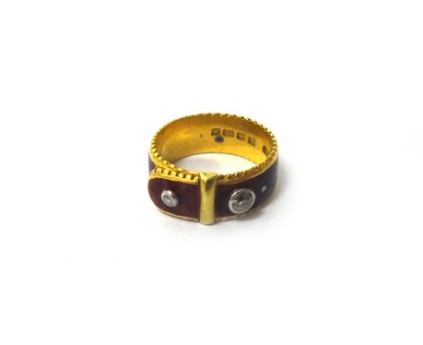 A 22ct gold, red enamelled and diamond set ring, in a buckle and strap design, mounted with two cushion shaped diamonds, Lond
