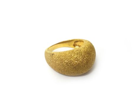 A gold ring, of bombe form, having a textured finish, ring size S, weight 9.8 gms, with a case.