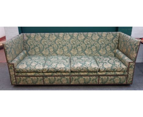 A 20th century Knole sofa in studded patterned green upholstery, 250cm wide x 82cm high, together with a matching armchair (2