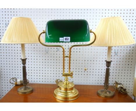 A Victorian style gilt metal desk lamp, modern, with a green glass shade on an adjustable arm and loaded circular foot, and a