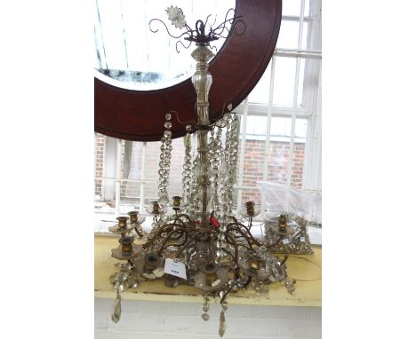 An ormolu twelve light chandelier, early 20th century, with cut crystal festoons and drops, (a.f.), 75cm high. 