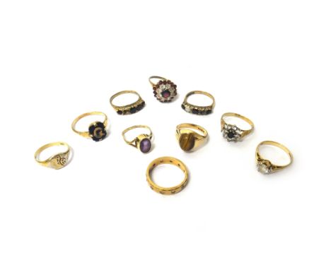 A 9ct gold, garnet and colourless gem set cluster ring, a 9ct gold ring, mounted with an oval tiger's eye, a 9ct gold, sapphi