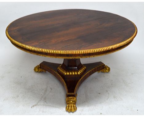 A Regency parcel gilt rosewood circular snap top breakfast table with split bobbin moulded edge, on a flared octagonal column