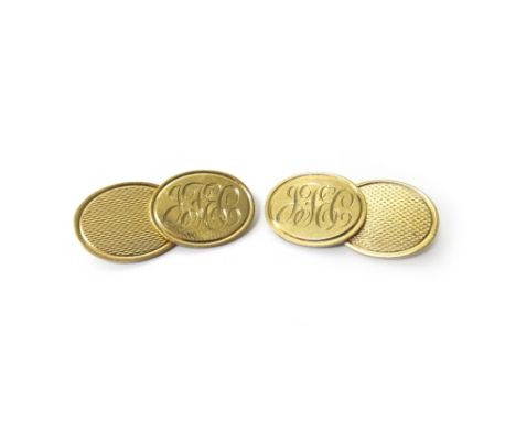 A pair of 9ct gold oval cufflinks, each engine turned to one side and monogram engraved to the other side, London 1974, weigh