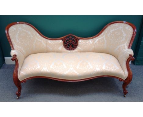 A Victorian carved and pierced walnut spoon back sofa, on scroll supports, 194cm wide x 86cm high. 