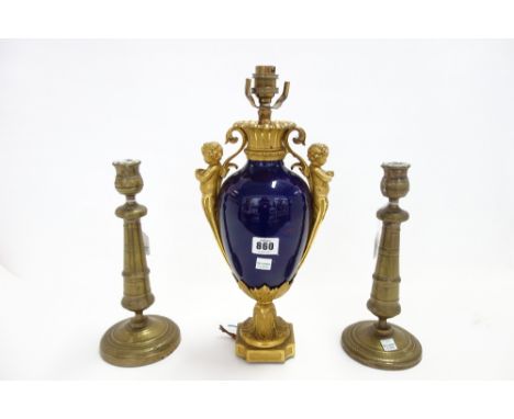 A French porcelain and ormolu mounted two handled vase, 19th century, the handles formed as cherub figures flanking a blue ov