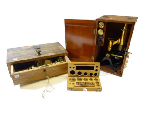 A Victorian mahogany cased microscope, with two eyepieces and a cased objective, a set of cased balance scales and a cased se