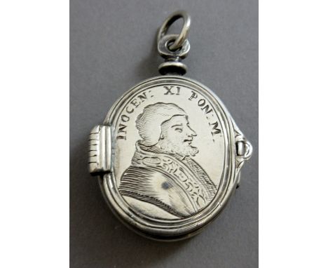 A 17th century European reliquary pendant locket, one side engraved with a portrait of Pope Innocent CI, the other engraved w