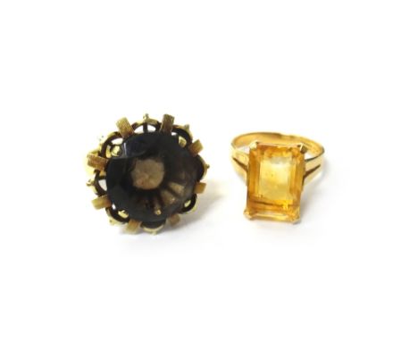 A gold ring, claw set with a rectangular step cut citrine, detailed 14 K 585, ring size L and a half and a gold ring, claw se