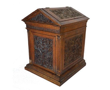 A Victorian carved walnut box of architectural form, with lifting roof over doors, 36cm wide x 45cm high.