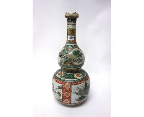 A Chinese famille-verte double gourd shaped vase, 19th century, the lower body painted with panels of figures in landscapes, 