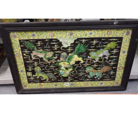 A Chinese porcelain rectangular plaque, late 19th/20th century, painted in a famille-verte palette with six  Buddhist lions a