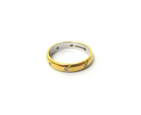 An 18ct yellow and white gold and diamond set eternity ring, mounted with circular cut diamonds, ring size L, with a case.
