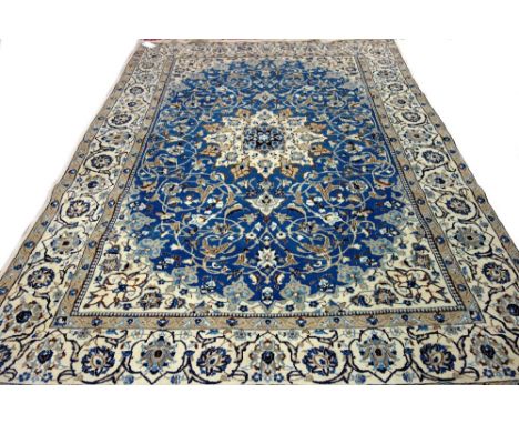 A part silk Nain carpet, Persian, the indigo field with an ivory cartouche medallion, matching spandrels, all with delicate f