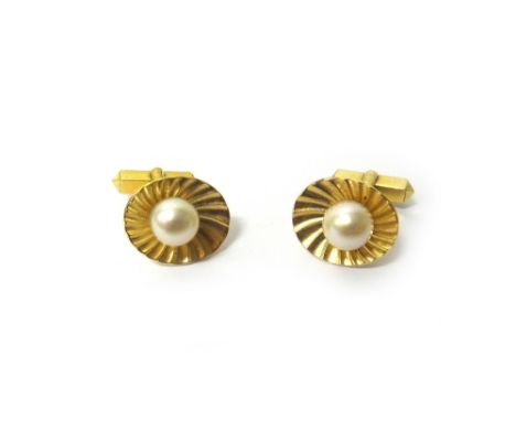 A pair of gold and cultured pearl cufflinks, the front of each mounted with a single cultured pearl, on a ridged oval dished 
