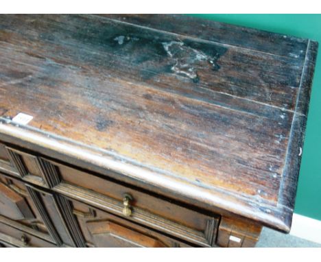 A Charles II oak two part chest of four long geometric moulded drawers, on bracket feet, 102cm wide x 99cm high. 
