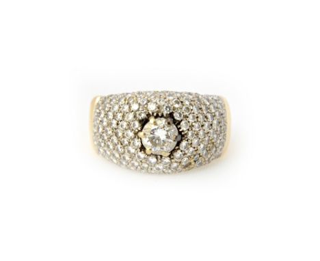 A gold and diamond set ring, in a bombe cluster design, claw set with the principal circular cut diamond at the centre and ot