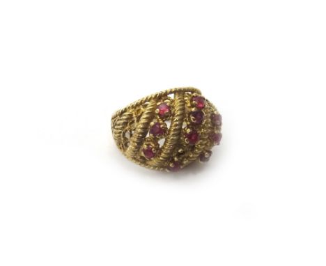 A 9ct gold and ruby set ring, in a bombe wirework design mounted with three rows of circular cut rubies (one ruby lacking) Lo