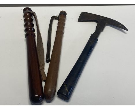 Two vintage wooden truncheons and a fireman's axe (right truncheon marked WDC 442)