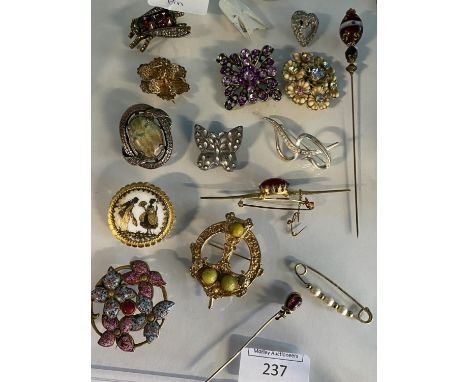 A selection of vintage brooches and pins etc