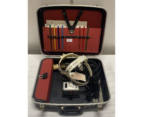 A vintage ophthalmoscope in case with accessories, shipping unavailable