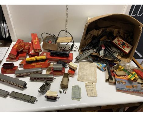A box full of assorted vintage 00 gauge railway models, mostly Triang. Includes railway loco, carriages, track, empty Triang 