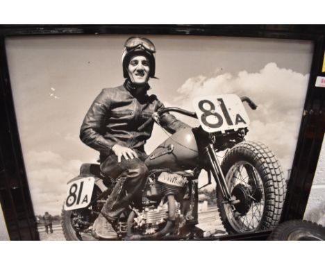 A black and white photographic print of a motorcycle rider