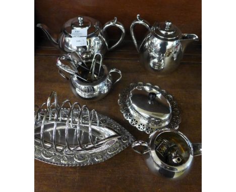 A four piece plated tea service, a navette shaped plated tea service, a cruet, a butter dish, three pairs of sugar bows and a