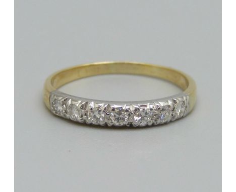 An 18ct gold, seven stone diamond half eternity ring, 2.2g, O 